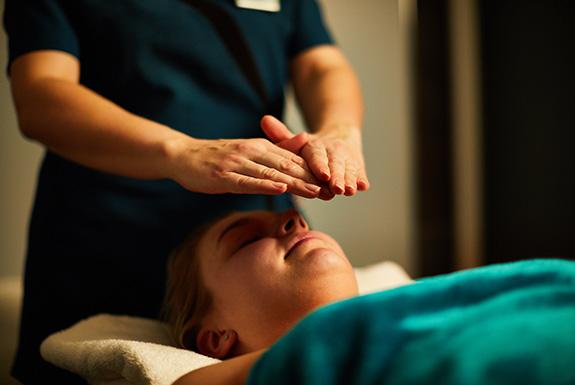 Person lying down having a facial