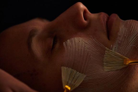 Person having a facial with brushes